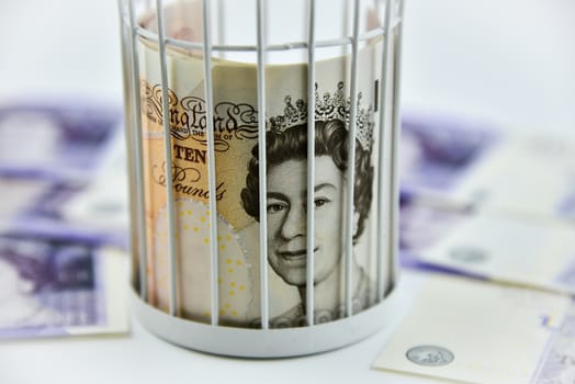 Banknotes trapped inside the cage, behind bars