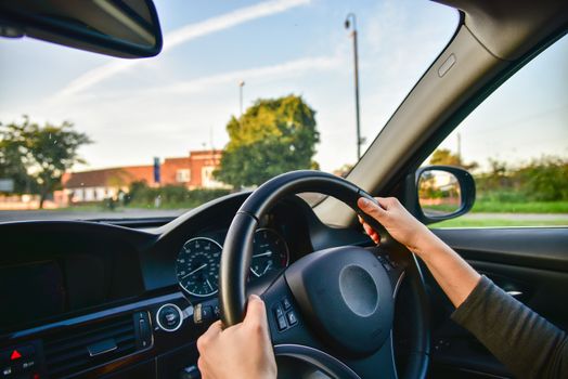 A woman driving a modern car.