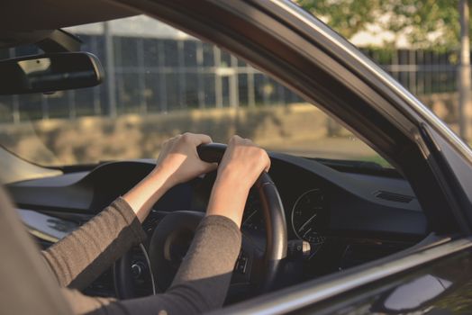 A woman driving a modern car.