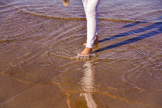 Lonely woman walking along the beach