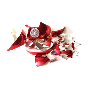 A smashed red holiday bauble has fallen to many pieces.