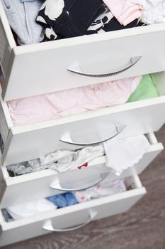 Messy clothes in wardrobe. Vertical photo