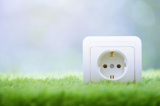 Electric outlet in the grass. Close-up photo