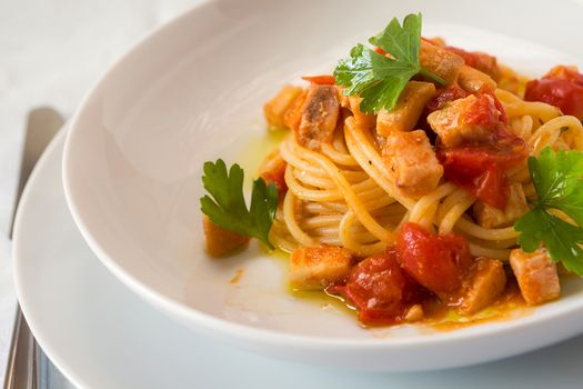 Spaghetti with fish little tomatoes and parsley