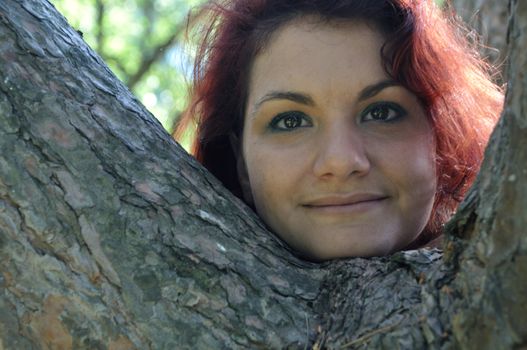 portrait of red  hair woman in a park