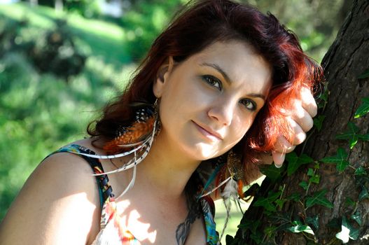 portrait of red  hair woman in a park