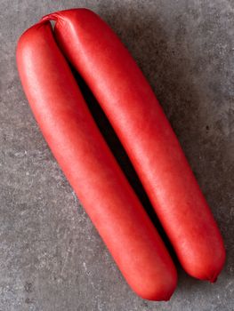 close up of rustic english saveloy red pork sausage