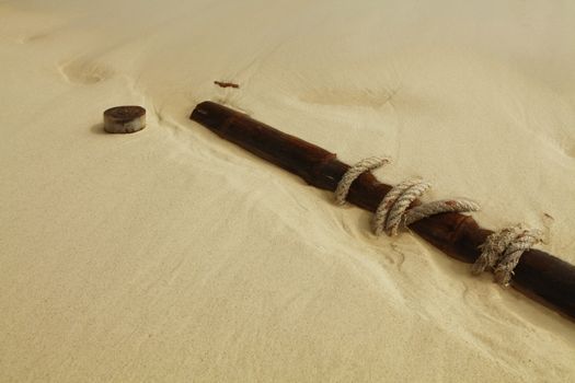 fragments from ship-wreck scattered on sand near sea