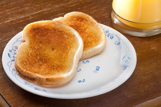 Nice breakfast of toast and orange juice ready to eat