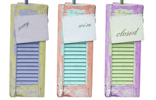 Three old decorative weathered wooden shutters with inscription Sorry were closed