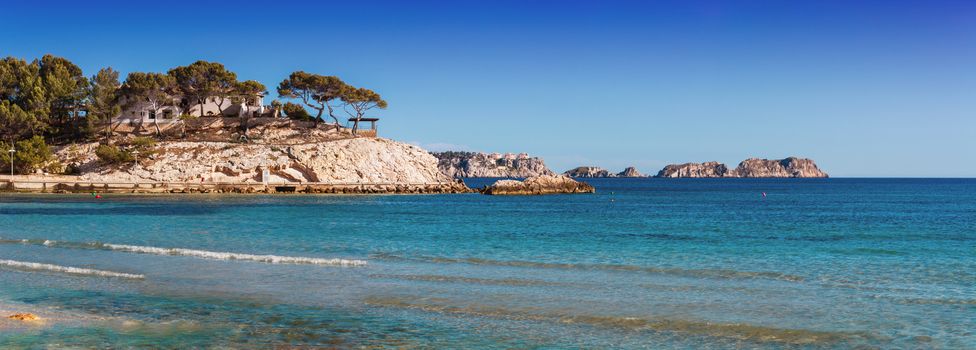 Panoramic views of the Bay of Paguera with a sandy beach and azure waters, Mallorca, Spain.