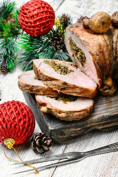 Dish of roulade of veal stuffed with mushrooms and spices and Christmas decorations