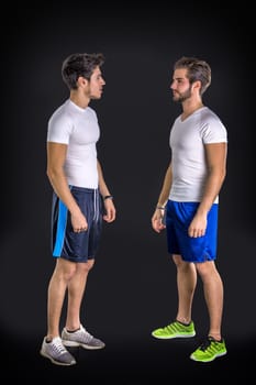 Two young good looking man wearing sportswear. Studio shot.