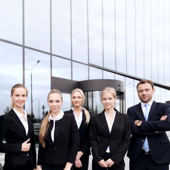 Portrait of friendly business group standing in line outdoors