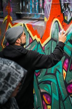 MELBOURNE, AUSTRALIA - SEPTEMBER 25: A street artist at work in Melbourne 's Hosier Lane, Australia on 25 September, 2016.