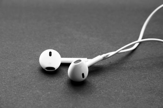 Headphones of white color isolated on black