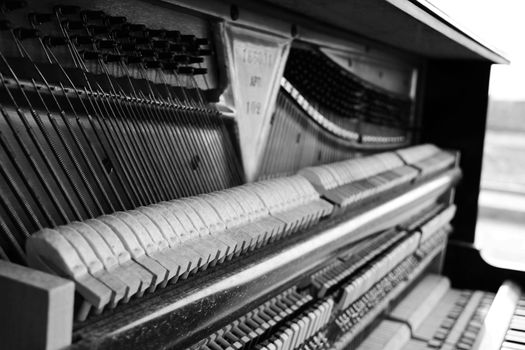 Old piano inside black and white close up