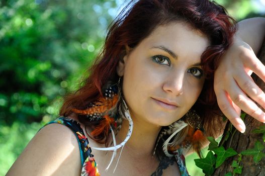 portrait of red  hair woman in a park