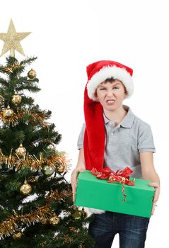 surprised boy in santa hat with christmas present on white background