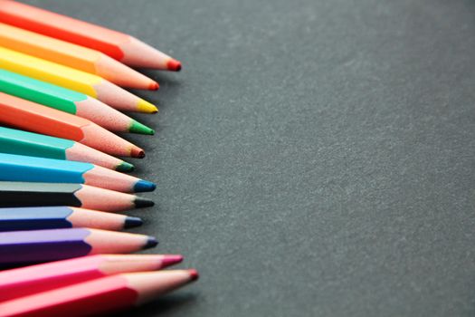 Pencils of different colors close up isolated on black