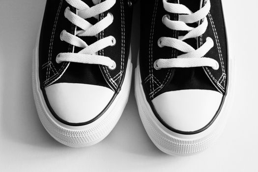 New black sneakers close up isolated on white