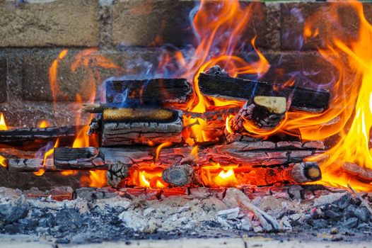 a flames on a Barbecue grill with lot of charcoal