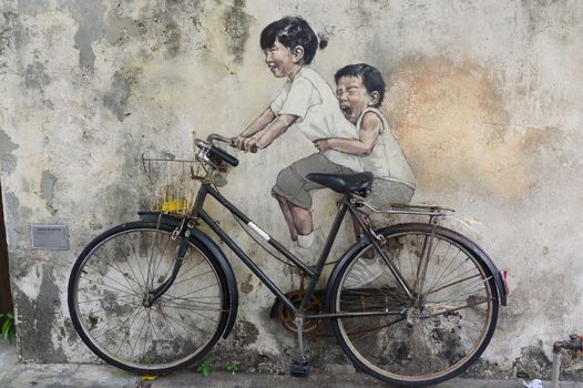 George Town, Penang, Malaysia - April 18, 2016: Little Children on a Bicycle street art mural by Lithuanian artist Ernest Zacharevic in Georgetown, Penang in Malaysia.