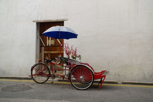 Georgetown, Penang, Malaysia - April 18, 2015: Classic local rickshaw in George Town, Penang in Malaysia