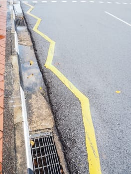 Sign on surface of street, yellow  zigzag line