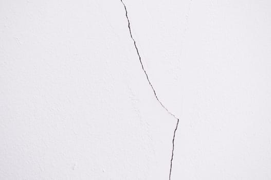 Crack old white concrete wall use as texture or background.