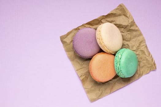 Creative photo of macaroons on purple background.