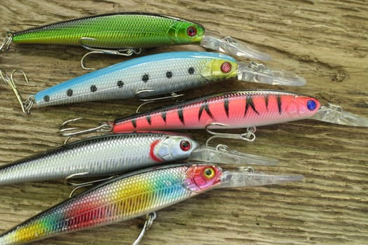 Spinning bait for fishing on wooden background