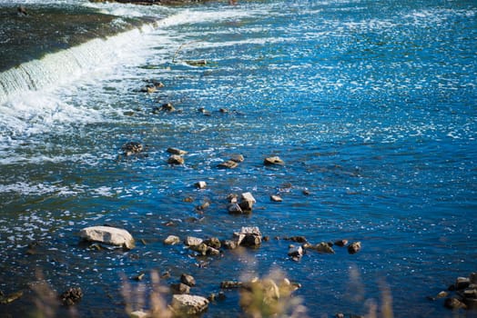 Wild vivid River with rocks and Rapids.