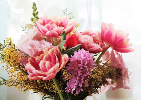 Bouquet of different flowers including tulips and mimosa