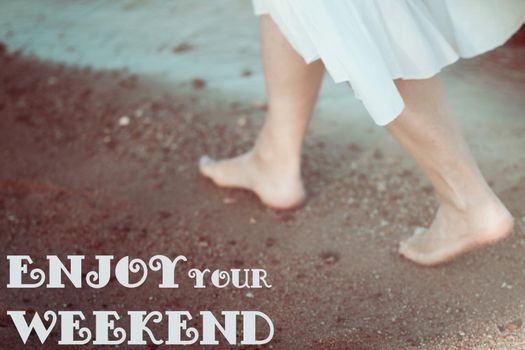 Young woman in white dress walking alone on the beach blured photo in vintage retro style blured