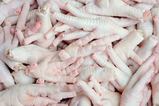 Uncooked chicken feet for food market background