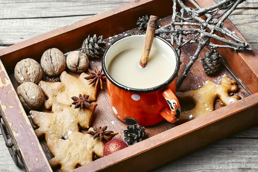 Christmas cookies with cup of hot coffee on a wooden box