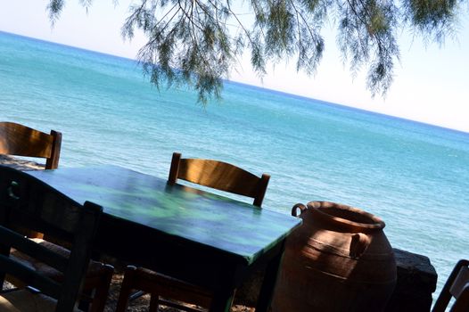 A table in the face of the ocean in a Cretan restaurant.