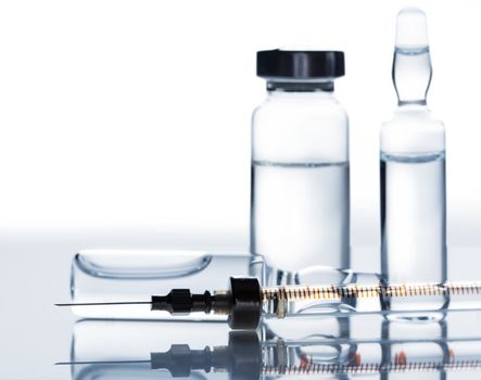 medicament in a glass vial and syringe closeup