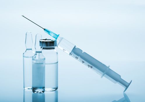 medicament in a glass vial and syringe closeup
