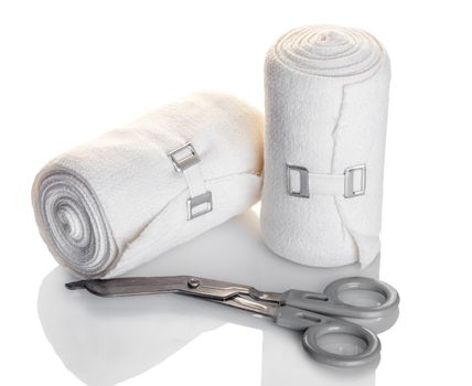 elastic bandage and scissors closeup white background