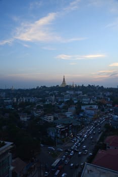 shwedagon pagoda surrounded by houses in yangon