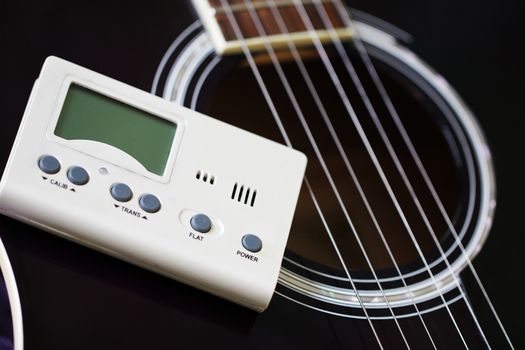 Guitar and tuner for toning musical instruments