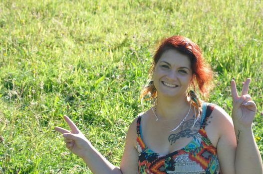 portrait of red  hair woman in a park