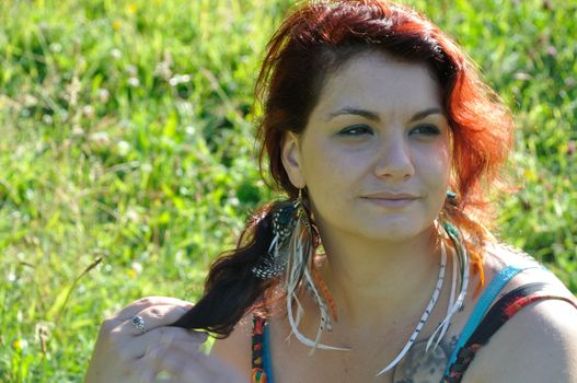 portrait of red  hair woman in a park