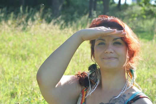 portrait of red  hair woman in a park