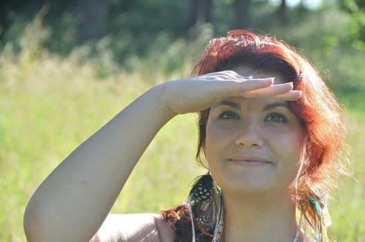 portrait of red  hair woman in a park