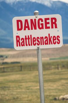 Rattlesnake warning sign in an american countryside
