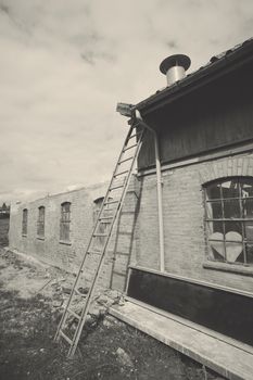 Ladder at an old weathered barn in black and white colors