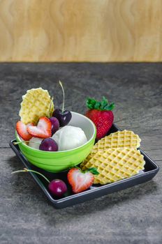 Vanilla ice cream scoops with fresh berries fruit